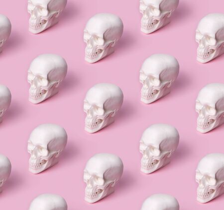 Skull seamless pattern on pastel pink background. Halloween costume party conceptの写真素材