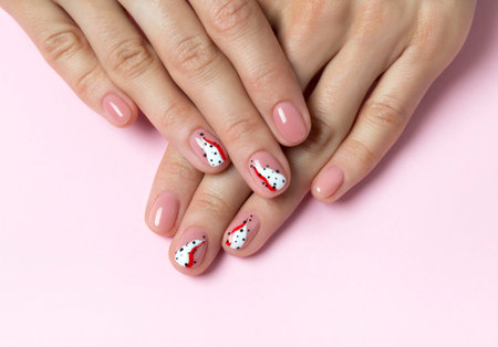 Bright fashionable abstract manicure on female hands. Nails design beauty salon concept