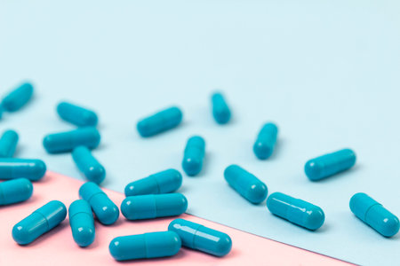 Blue pills on pink background. Template for feminine beauty blog social media. Female healthcare...