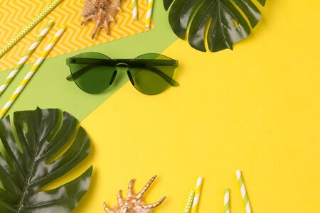 Modern fashionable green sunglasses on creative yellow background. Fashion blogger summer beach conceptの写真素材