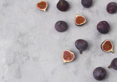 Pattern with fresh ripe figs on a gray concrete background. Healthy mediterranean fruits top view copy spaceの写真素材