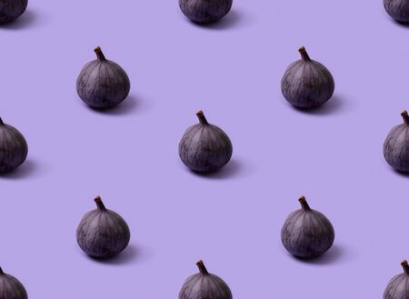 Seamless pattern with fresh ripe figs on a purple background. Healthy mediterranean fruits top view copy spaceの写真素材