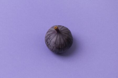 Fresh ripe fig on a purple background. Healthy mediterranean fruit with copy spaceの写真素材