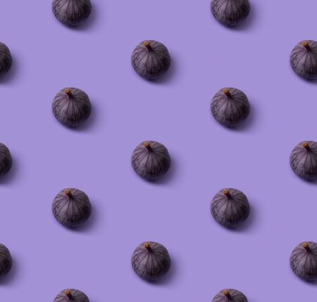 Seamless pattern with fresh ripe figs on a purple background. Healthy mediterranean fruits top view copy spaceの写真素材