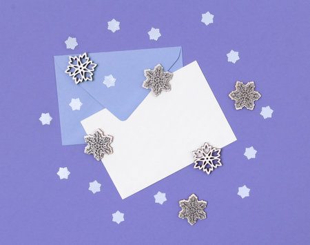 Envelope with letter and snowflakes on purple background. Creative winter composition. Template mock...