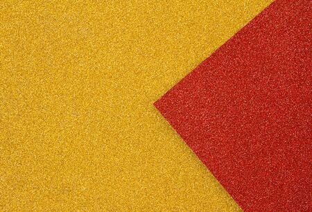 Abstract colored paper art background of trendy colors. Red with gold glittering backdrop in minimal style. Flat lay, Top view.の写真素材