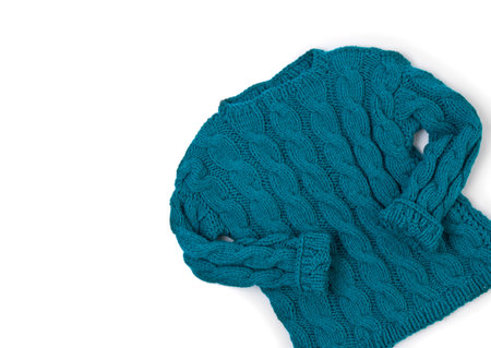 Flat lay top view turquoise cozy knit sweater on white background
