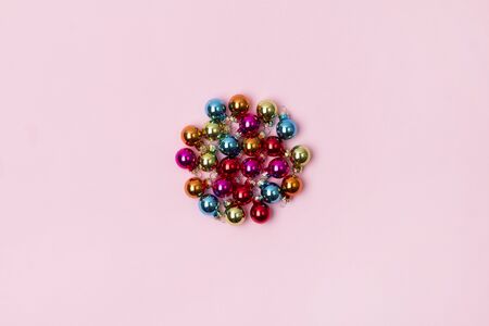 New Year Christmas top view flat lay colorful bauble with copy space on pink background. Feminine template for blog social media or postcardの写真素材