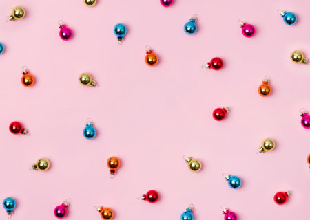 New Year Christmas top view flat lay colorful bauble with copy space on pink background. Feminine...