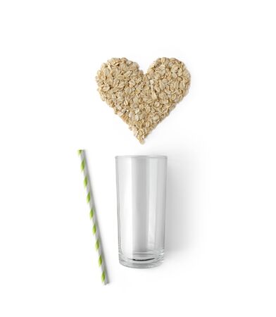 Creative composition with glass, straw and oatmeal isolated on white backgroundの写真素材
