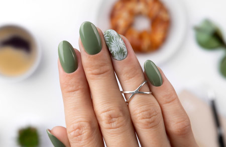 Beautiful womans hand with spring summer floral nail design