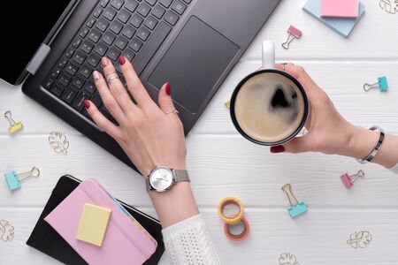 Woman with minimal pink spring summer manicure design typing on keyboard. Work from home female business conceptの写真素材