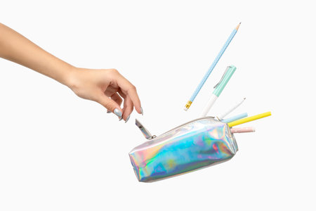 Womans hand and office supplies stationery levitate over white background. Back to school work...