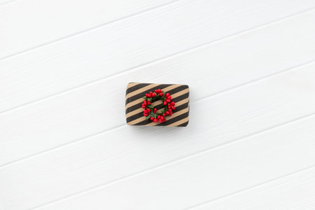 Christmas present over white wooden background. Minimalist eco friendly zero waste new year...
