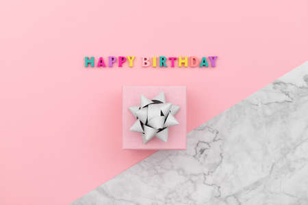 Happy birthday inscription from wooden colorful letters with gift boxの写真素材