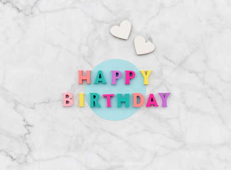 Happy birthday text from wooden colorful letters with heartsの写真素材