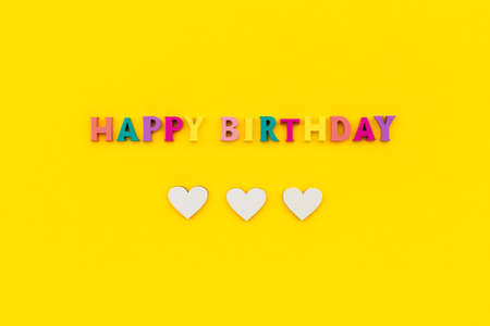 Happy birthday text from wooden colorful letters with heartsの写真素材