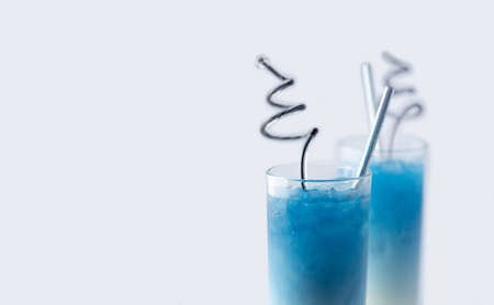 Summer refreshing beverage blue butterfly pea latte in glass on white backgroundの写真素材