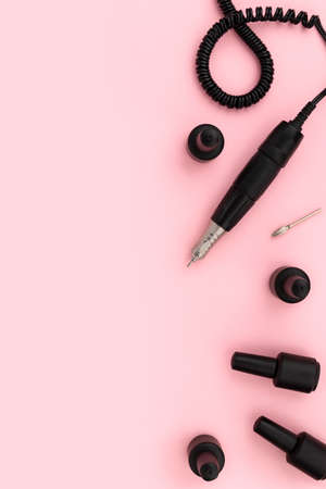 Flat lay top view equipment for manicure on pink background. Mock up template for beauty salon with copy spaceの写真素材