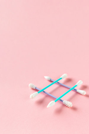 Reusable silicone swab on pink background. Alternative to cotton buds flat lay top view. Eco friendly sustainable life style conceptの写真素材