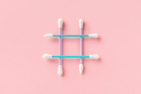 Reusable silicone swab on pink background. Alternative to cotton buds flat lay top view. Eco friendly sustainable life style conceptの写真素材
