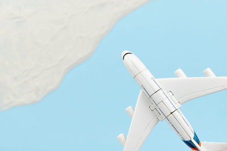Creative composition with toy airplane and sand