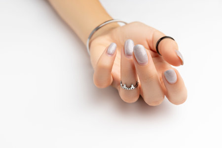 Womans hand with grown manicure on white background with copy spaceの写真素材