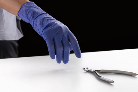 Master in the beauty salon takes the tools for the manicure