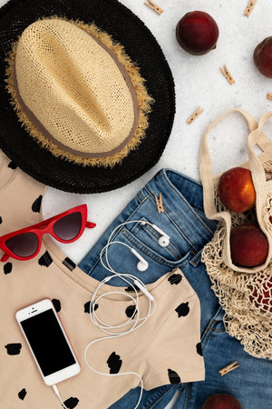 Womens summer clothes and accessories on gray background