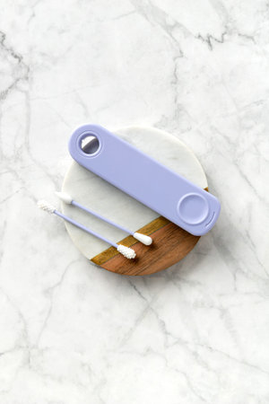 Flat lay top view violet reusable silicone swab buds on white marble background