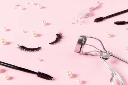 Creative layout with make up accessories on pastel pink backgroundの写真素材