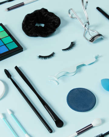 Creative layout with make up accessories on pastel blue backgroundの写真素材