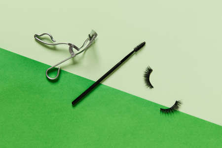 Creative layout with make up accessories on green backgroundの写真素材