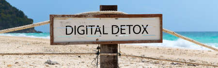 Empty wooden signboard against tropical sand beachの写真素材