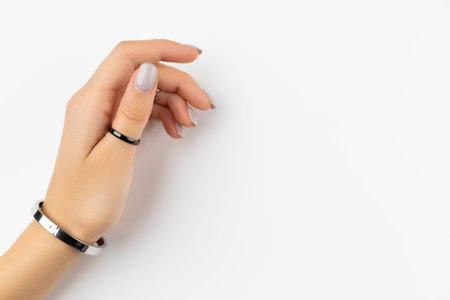 Womans hand with grown manicure on white background with copy space