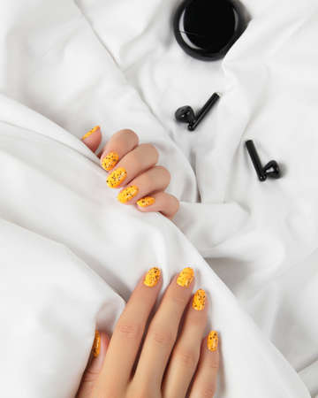 Manicured womans with trendy nail design on bed. Beauty treatment self careの写真素材