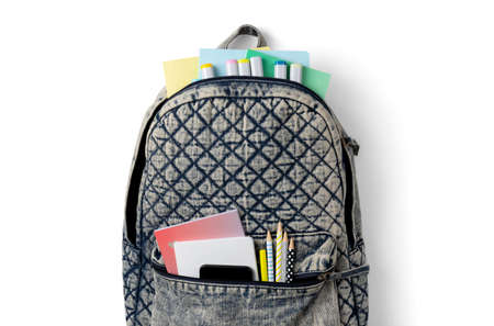 Flat lay top view backpack with different colorful stationery on white tableの写真素材