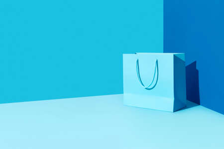 Paper shopping bag on blue background. Shopping sale delivery conceptの写真素材