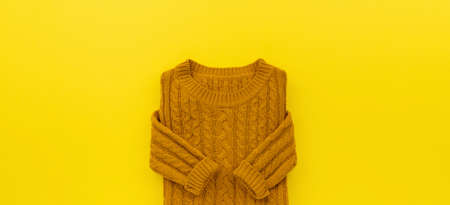 Womens autumn sweater on yellow wooden backgroundの写真素材