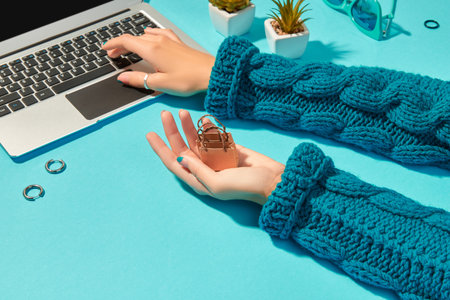 Womans hands with fashion clothes and accessories on blue backgroundの写真素材