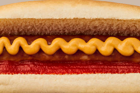 Classic hot dog with wurst, ketchup and mustard macro. Menu for restaurantの写真素材