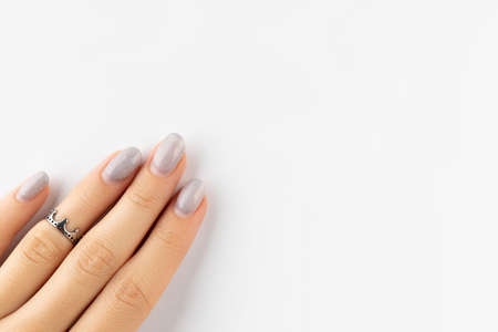 Womans hand with grown manicure on white background with copy spaceの写真素材