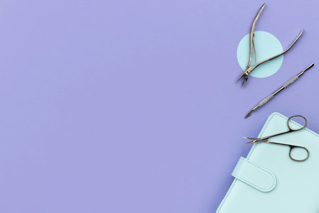 Set of cosmetic tools for manicure and pedicure on a purple background