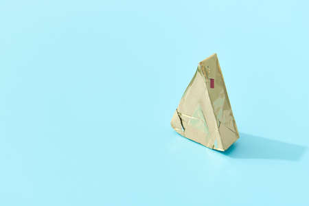 Processed cheese on blue background with deep long shadows. Minimal creative food conceptの写真素材