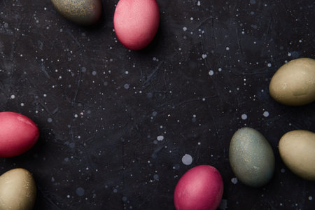 Dyed eggs on black background. Easter celebration conceptの写真素材