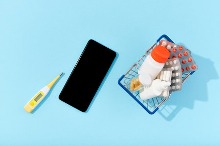 Different medicine pills and smartphone. Buying online drug delivery conceptの写真素材
