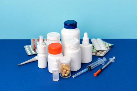 Different medicine pills on blue table. Healthcare pharmacy and medicine concept