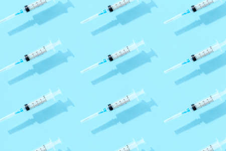 Medical syringes on a blue background. Healthcare pharmacy and medicine conceptの写真素材