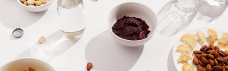 Dried fruits and nuts with sauce on white background with sunlight