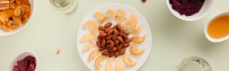 Dried fruits and nuts with sauce on green background with sunlight